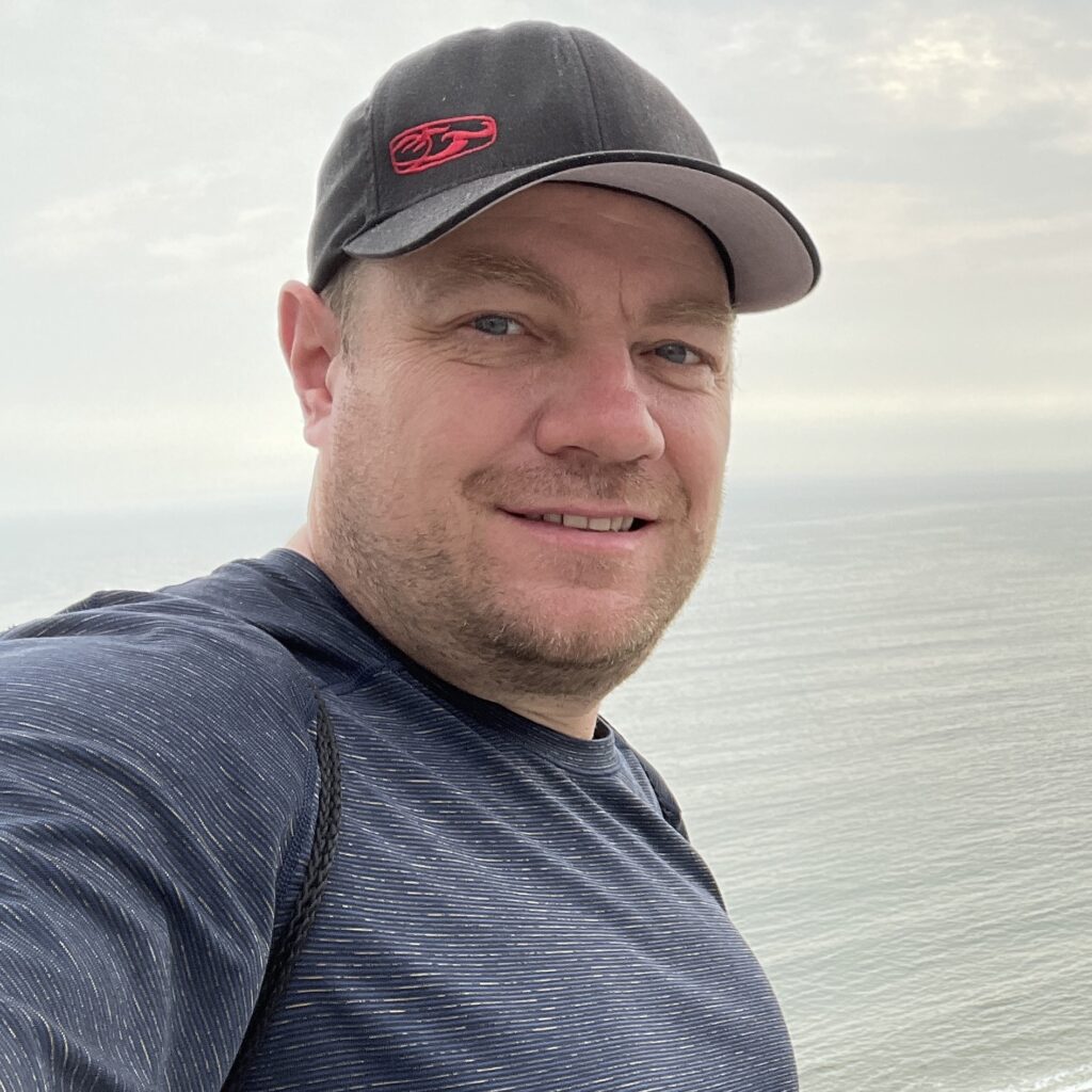 Scott Cate with a hat on overlooking the ocean in Lima, Peru